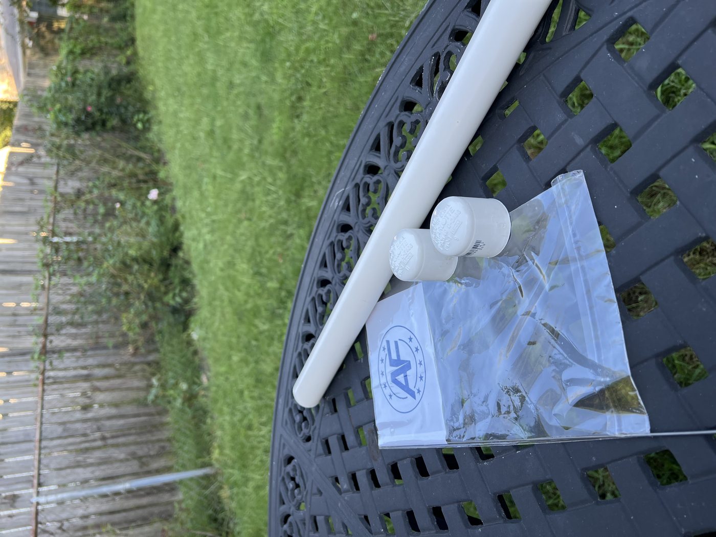 Flag kit with shipping tube, caps, and sleeve on a table